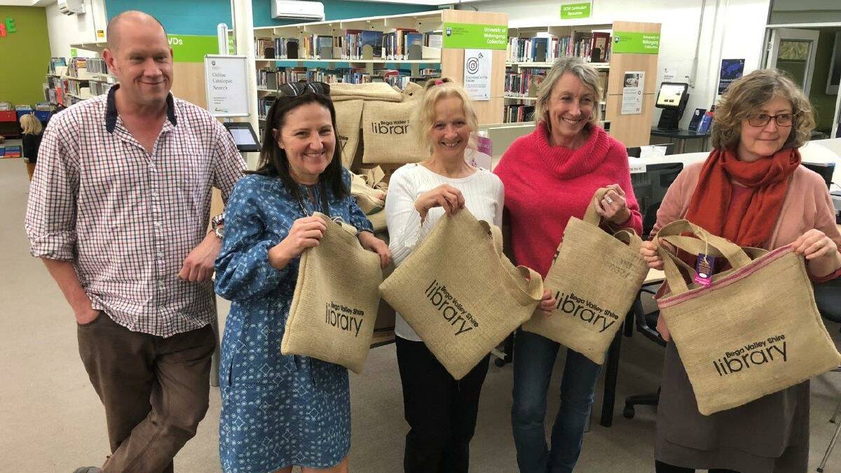 Tulgeen representatives with council staff presenting the first lot of library bags at Bega library. 