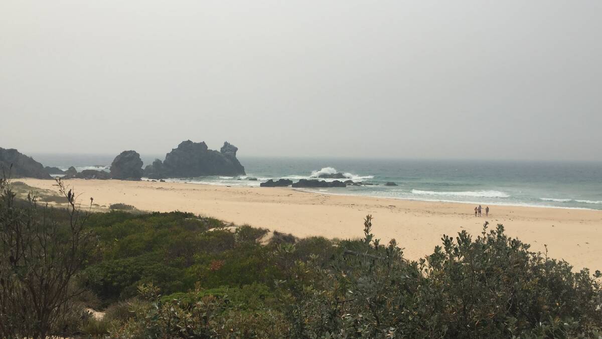 Camel Rock, north of Bermagui, was covered in thick smoke on Wednesday morning. 