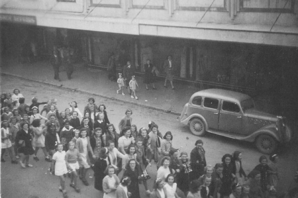 END OF THE WAR: Children celebrate the end of World War Two by joining the procession down Carp Street, Bega to the showground. 