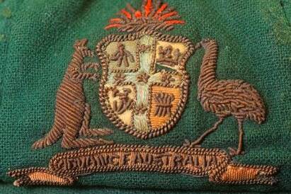COAT OF ARMS: A close up of the coat of arms on Sir Donald Bradman's first baggy green which was auctioned online through Pickles.com.au. Photo: Pickles. 