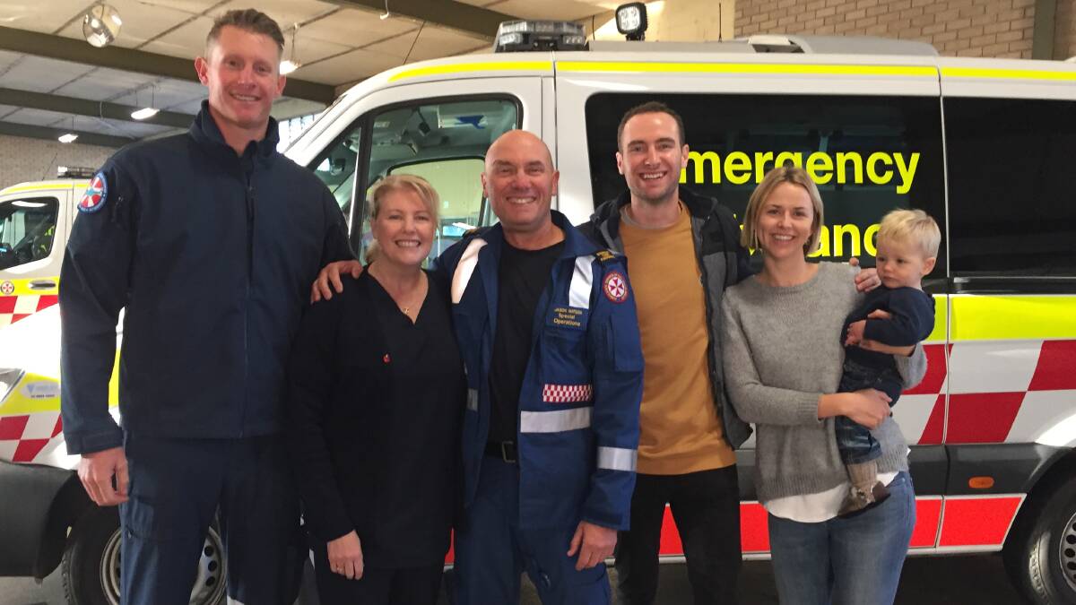 Shoalhaven NSW Ambulance Rescue Paramedic Jason Watson with his wife Lisa, son Chris , son-in-law Nathan Haythorpe and daughter-in-law Tarryn nurisng grandson William.