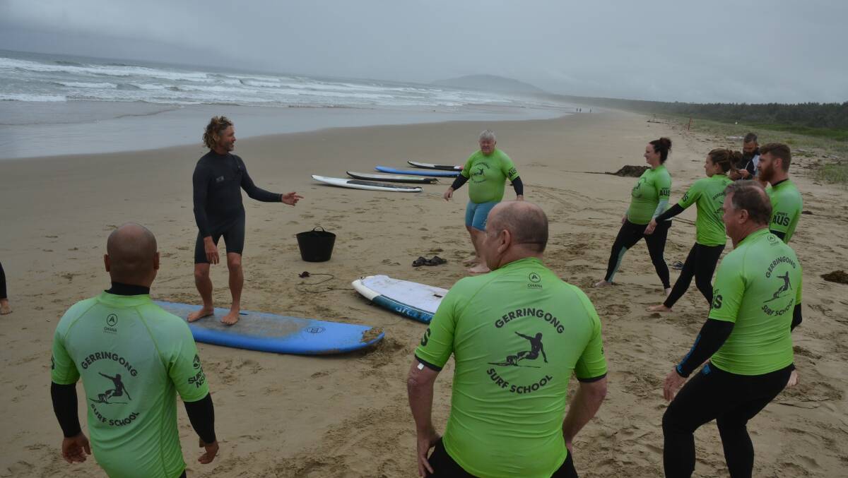  INSTRUCTION: Veterans Surfing Program co-ordinator Rusty Moran takes the initial participants in the pilot program through some surfing basics.