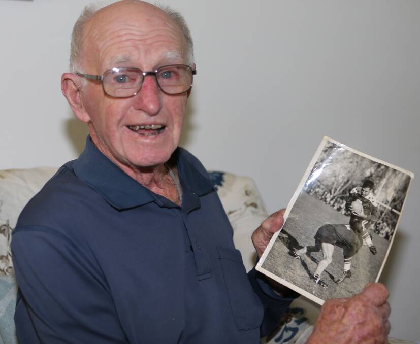 One of the oldest surviving Pyree Rovers players the late Greg Watts with a photo of him tackling his opposite number Ed Demirjian while playing for Southern Districts against the touring American All Stars at Manuka Oval in Canberra on Wednesday, May 27, 1953. 