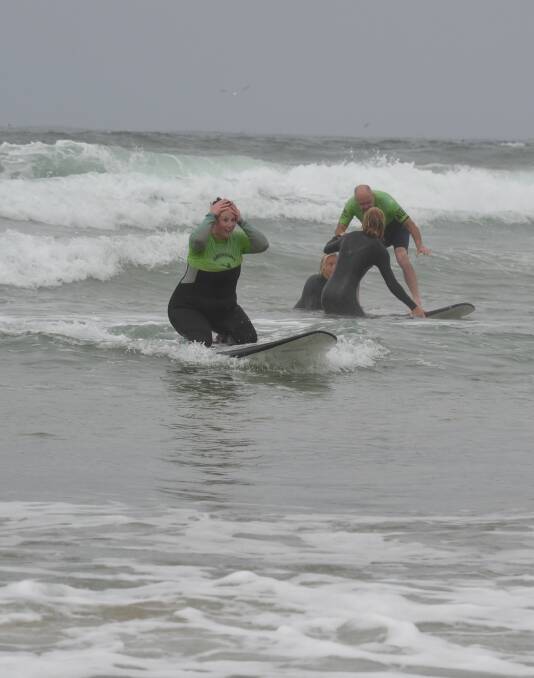 WOW: The expression on Suz Dendle's face says it all as she catches a wave as part of the Veterans Surfing Program.