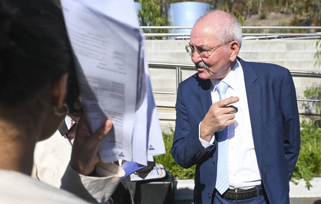 Mary-Anne Thomas' adviser puts up papers to obscure the minister from The Border Mail's photographer as she chats to Wodonga mayor Ron Mildren. Picture by Mark Jesser 
