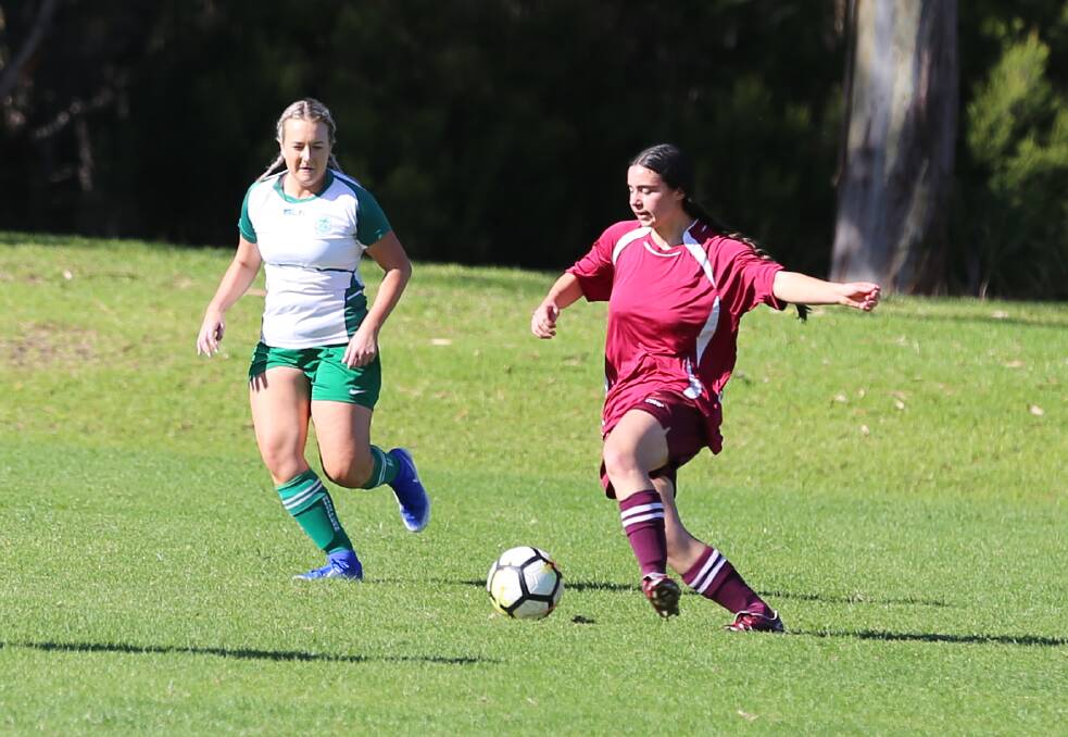 A Tathra defender clears the ball forward during their 2-0 loss to the Grasshoppers at Berrambool on Sunday. 