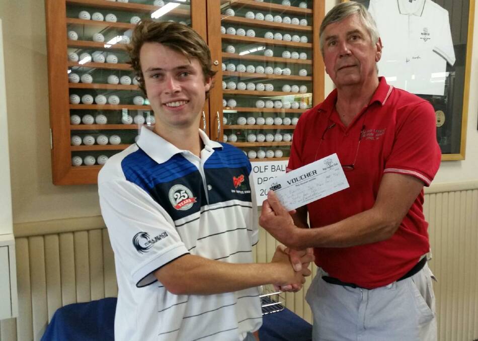 On the ball: Young gun Jack Roberts accepts the A grade voucher from Bega men's golf captain Dave Hancock after a great round. 