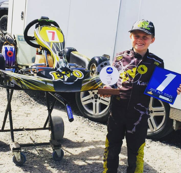 State champ: Go karter Aidan Williams proudly shows off his Blue Plate ACT Championship after a win at Mark Webber Circuit recently. 