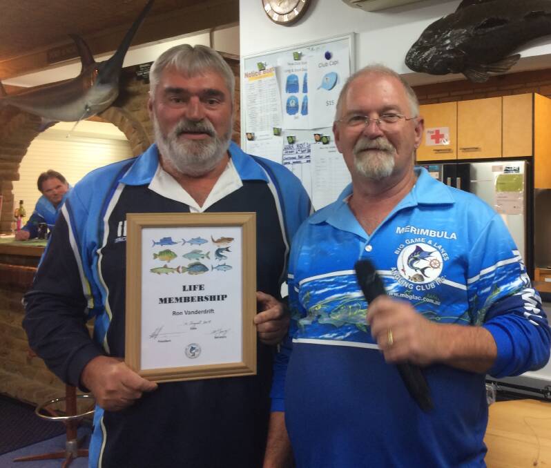 Rare honour: Ron Vanderdrift formally accepts his Life Membership award from Merimbula Big Game and Lakes Angling Club President Lindon Thompson. 