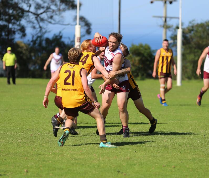 A Tathra Sea Eagles gets wrapped up by Pambula players in round one, with the Panthers scoring a decisive win on Saturday. 