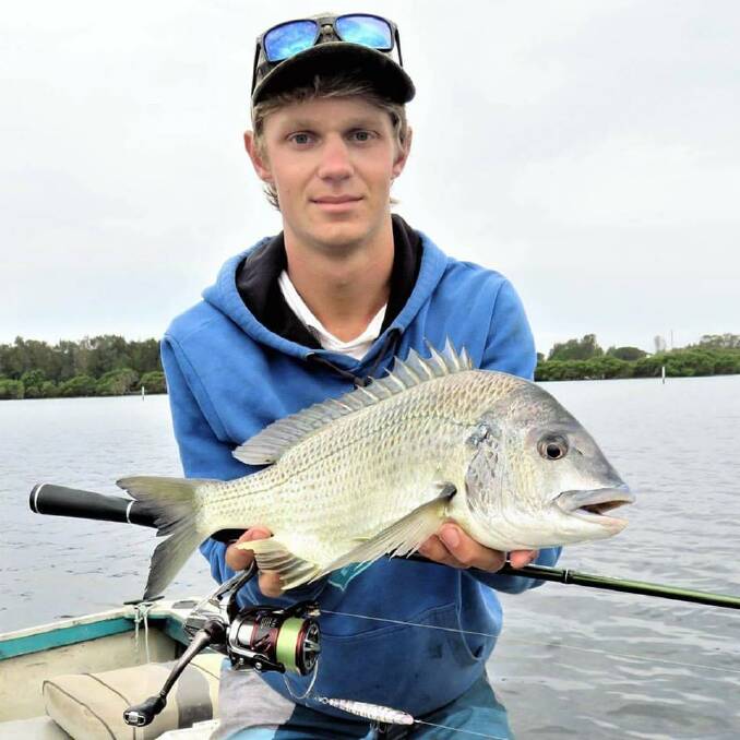 Lovely fish: Jasper Dulhunty of Millingandi with a catch-and-release bream in Merimbula Lake. Good trevally and bream are about at Pambula and the Bega River and in the lower reaches of Merimbula Lake. 