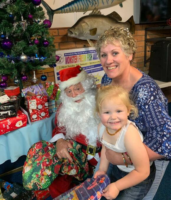 Festive fun: Club treasurer Keryn Wilkin, her granddaughter Olivia and Graham Bywaters disguised as Father Christmas, enjoy MBGLAC's wonderful Christmas party last week. 