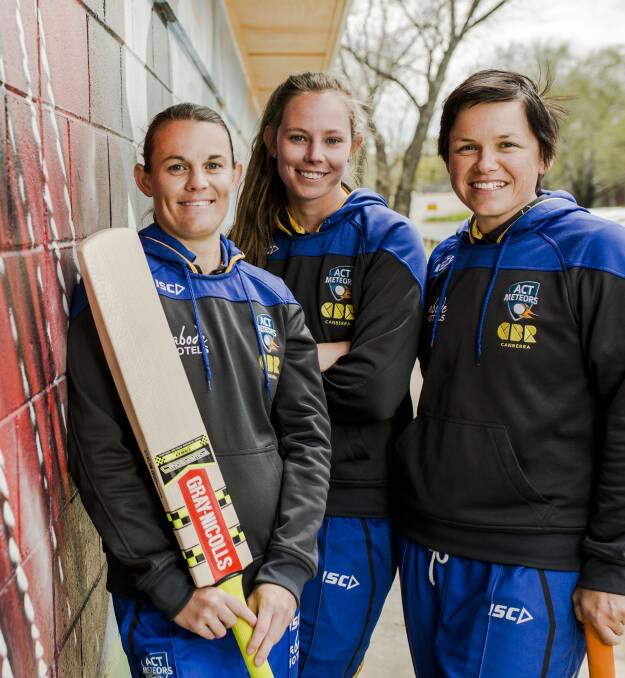 Kris Britt (right), with Meteors team-mates Erin Osborne and Sam Bates, is excited about girls try days for cricket and coaching sessions. 