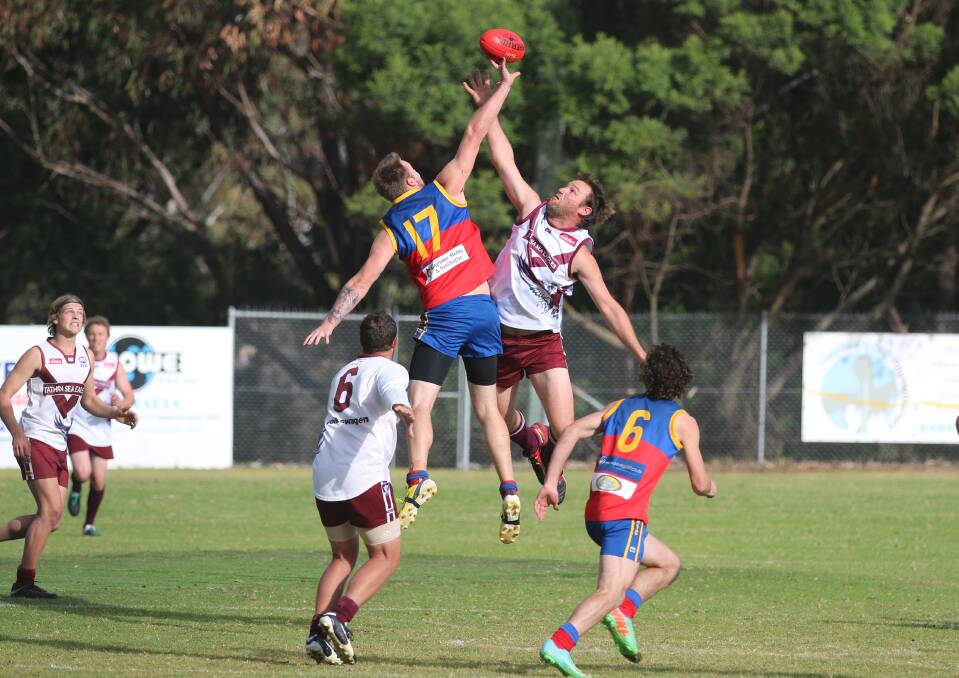 Ball up: Tathra ruckman Rick Spink goes airborne against the Narooma Lions in a recent outing. The Lions claimed a win on Saturday. 