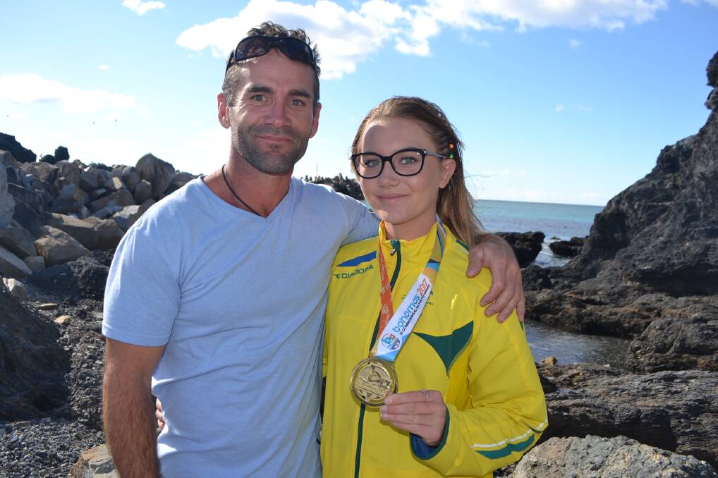 Lilly-Rose Bennett with her dad Justin celebrate her Commonwealth Games gold last year with the rising star breaking her leg on Sunday. 