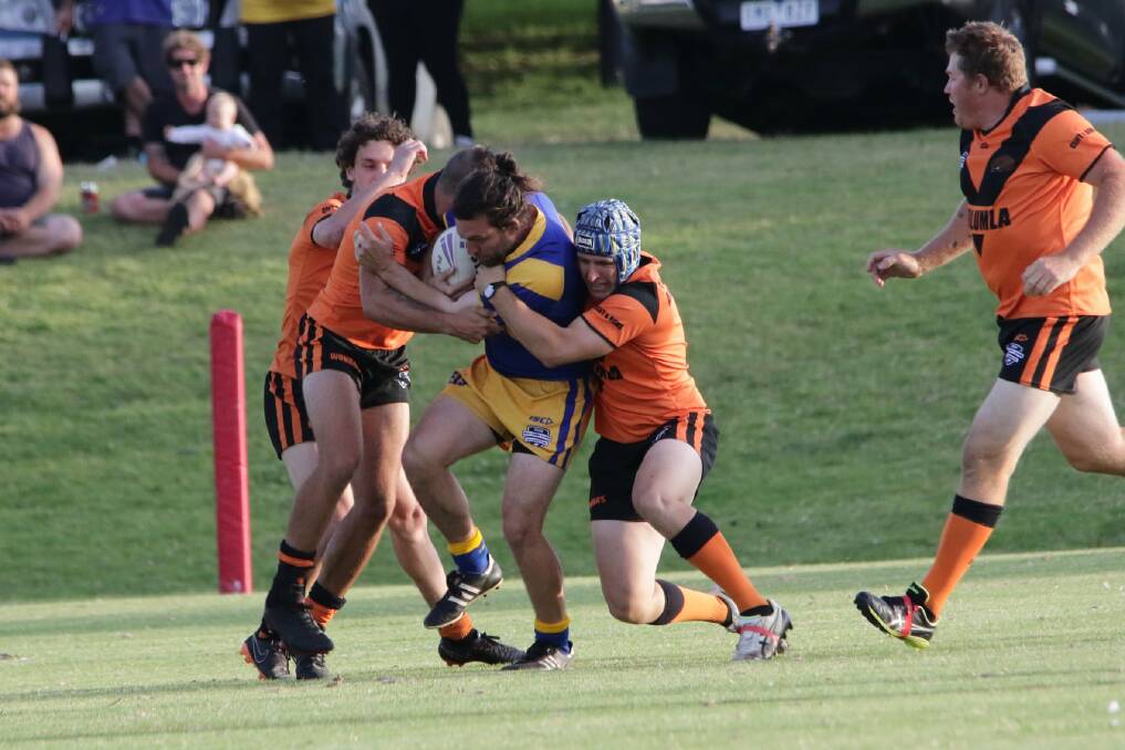 Wrapped up: Pub comp organiser Scott Barton wraps up Cobargo-Bermagui Eel Tom McMillan during Friday's grand final. Picture: Peter Sheales. 