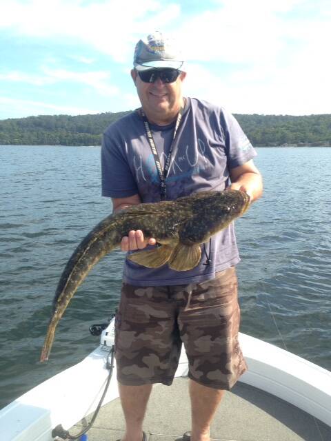 Back you go: Glen Rollason shows a lovely catch and release dusky flathead at Mogareeka.