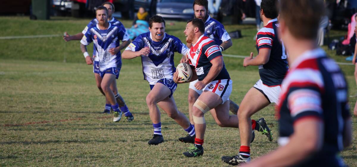 Prop charge: Jarrod Tamatea on the burst for the Bega Roosters against the Merimbula-Pambula Bulldogs in Eden gets eyed up by Jack McGuire for a tackle. 