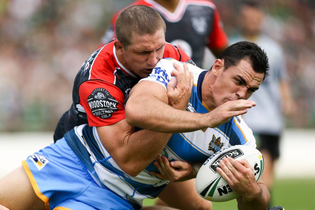 Eyeing up a spot: Morgan Boyle gets tackled by the Warriors' Ryan Hoffman in a trial match last week and has been named on an extended bench for the Titans. 