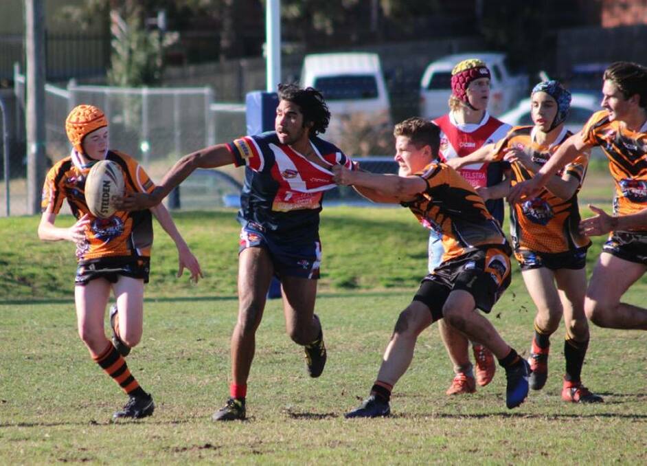 Minor league finals: Kevin Dixon fires a flick pass to the outside for the Roosters under 16s who will look to reverse the score against the Bay on Sunday. 