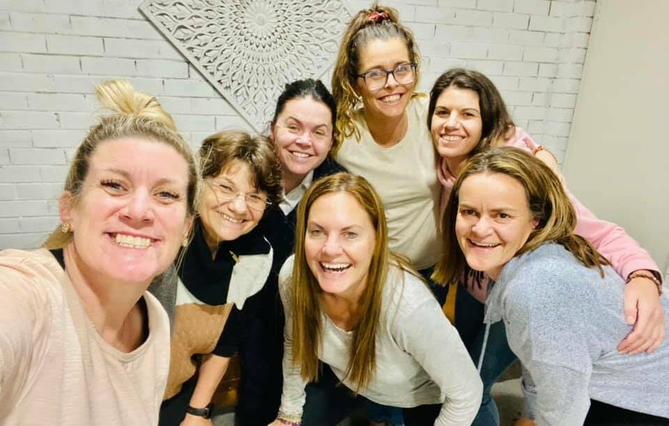 Amanda Harris (back, second from right) is an AusMumpreneur Award finalist for her healing business and women's circles. Picture: supplied. 
