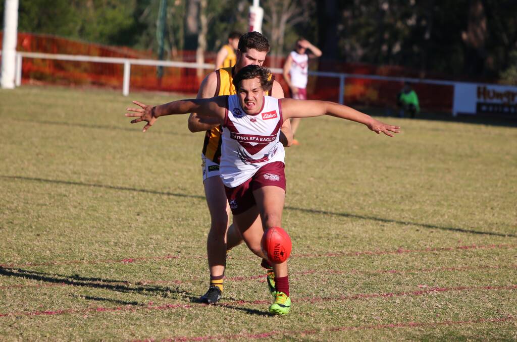 Not yours: Dennis Paratene shepherds ball away from a Pambula opponent when the two clubs met earlier in the season. 