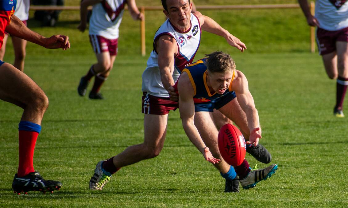 Tackle contest: Tathra's Jordan Rettke runs down his Narooma opponent during the opening round of SCAFL at Narooma on Saturday. Picture: Kim Harris. 