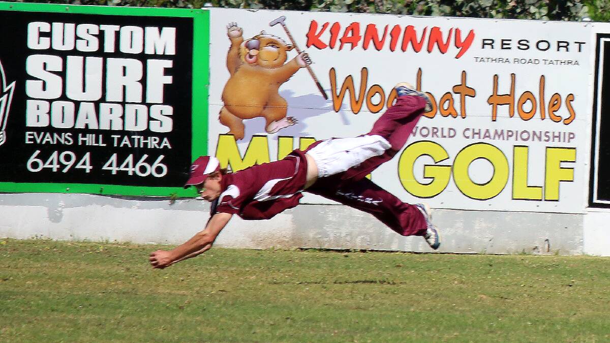 Chris Dwyer, pictured in a diving catch, hit 116 runs for Tathra on Saturday as the team climbed to 3/358. 