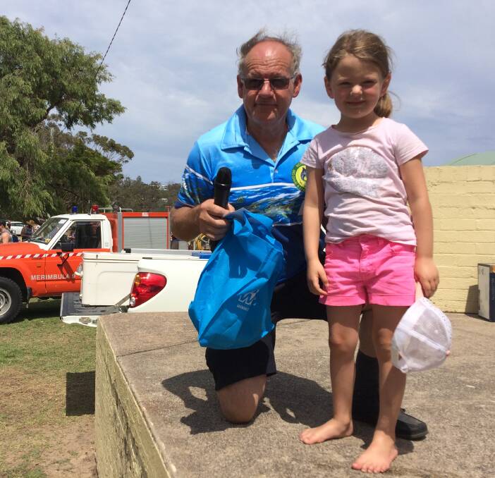Little tacker: Junior angler Lila DeSantis receives a gala prize for her bag of estuary fish from MBGALAC president John McKay during the club's 81st gala competition on Sunday. 