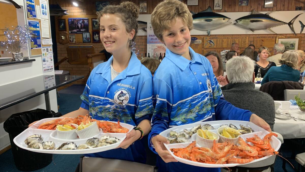 It's almost party time: Juniors Sinead McKay and Eli-Sky Vitouchova with examples of the tasty seafood that will feature at the club's Christmas party on December 13. 