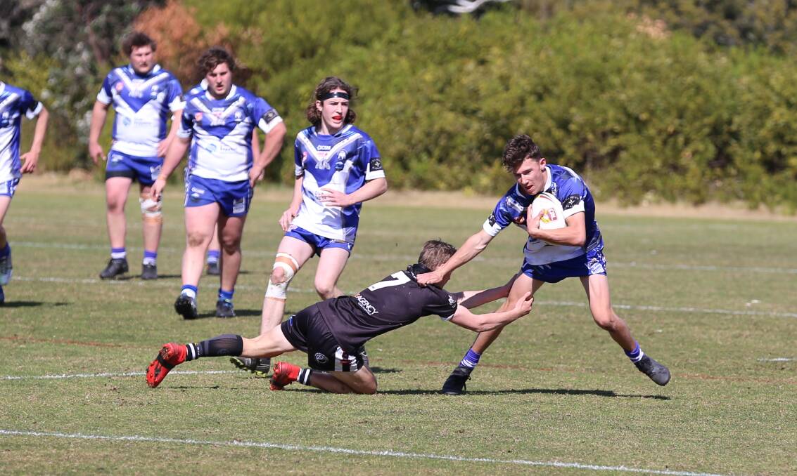 A Bulldog sidesteps a tackle attempt in their win over the Cooma Stallions that was marred by on-field altercations on Sunday. 