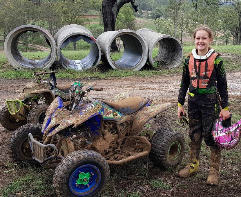 Mud therapy: One of the Quik Chix is all smiles after a quick blast around a muddy circuit recently with a duo of quad racers to visit for the Motorcyle Expo. Picture: supplied.