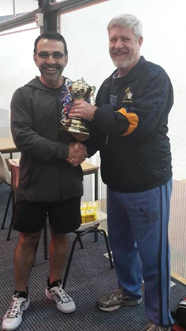 John Stylianou presents the 'Rashes' to Scott Caban, president of the ACT club after the annual inter-club weekend. 