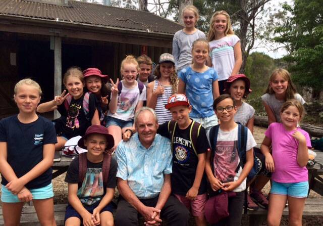 Lifelong educator: Former Tathra Public School principal Terry Dickson catches up with pupils during a camp in 2017. Picture: Tathra Public School. 