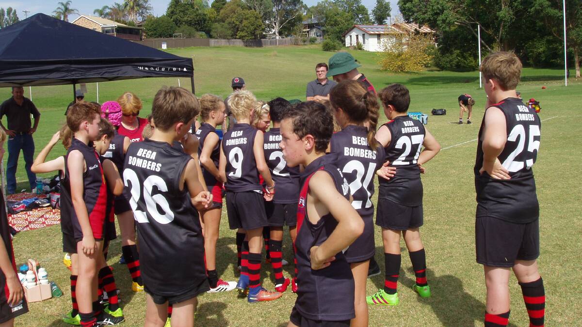 Family focus: Young players huddle up during a half-time talk at the Bombers' home ground of Roy Howard Oval in Bega. 
