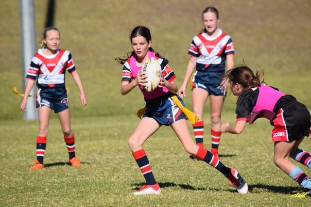 Breaking loose: A Bega junior league tag team member dashes through a tag attempt into free space on Saturday. Picture: Wendy Deighton. 