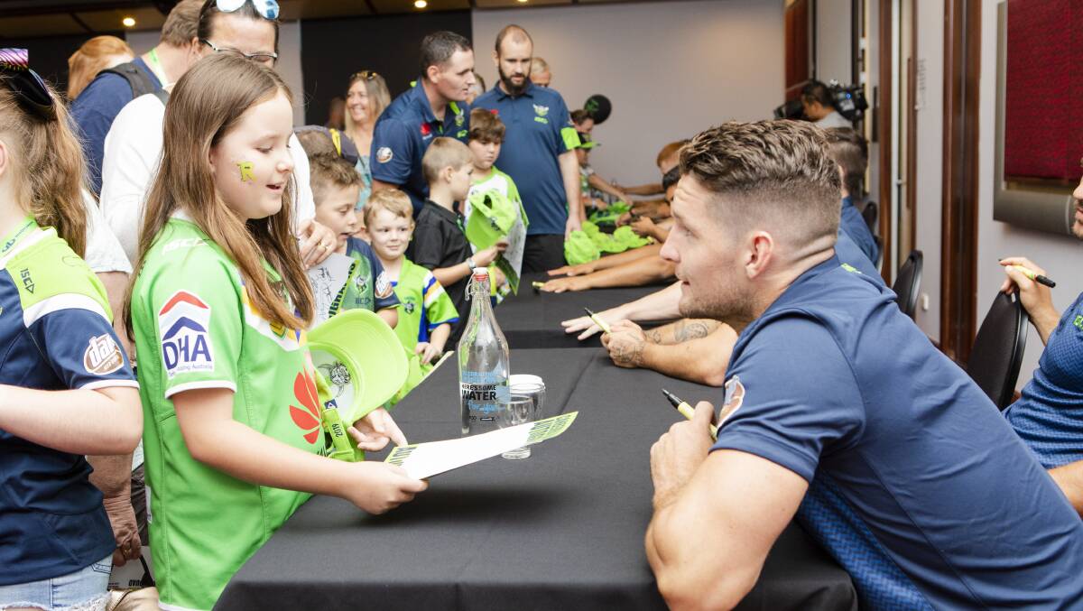 Club visits: Raider Jarrod Crocker chats with young fan Darcie Wood, 10, during a signing over the weekend. 