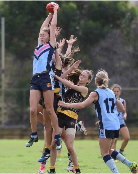 Big reach: Tarni Evans bests a number of players, getting her fingertips to a high mark during the under 15s National Championships in Perth. Picture: supplied