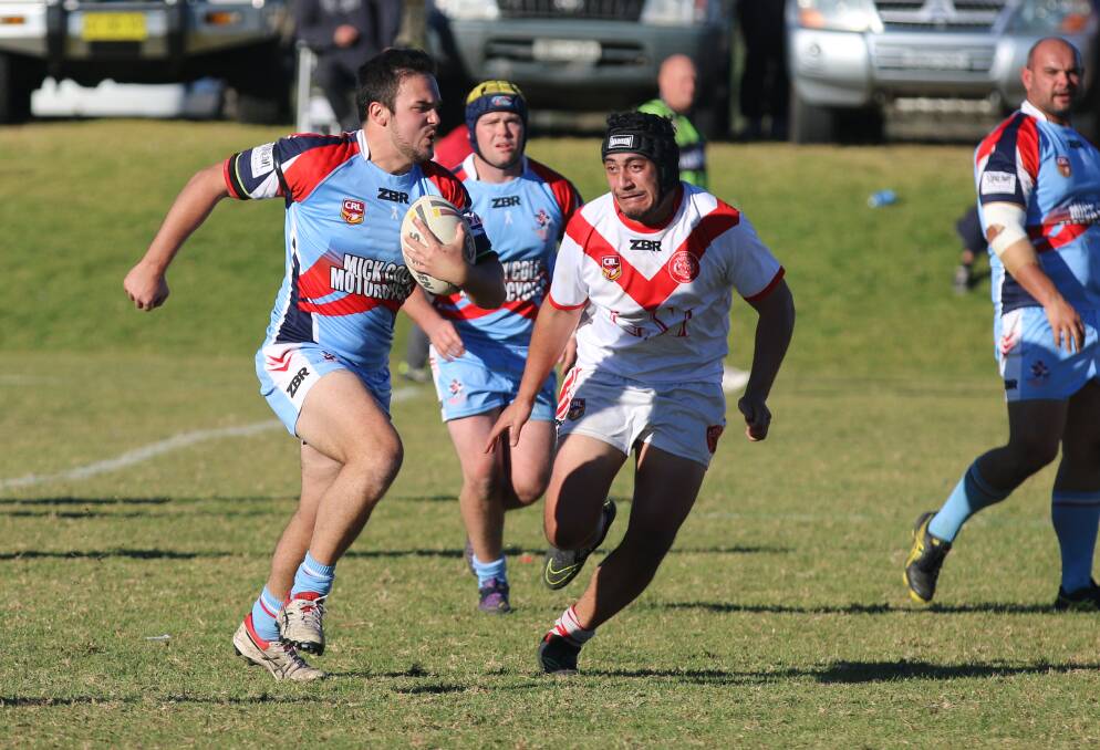 On the burst: Luke Dowdle makes a run for the Bega Roosters with Eden prop Elvis Tui closing the gap.