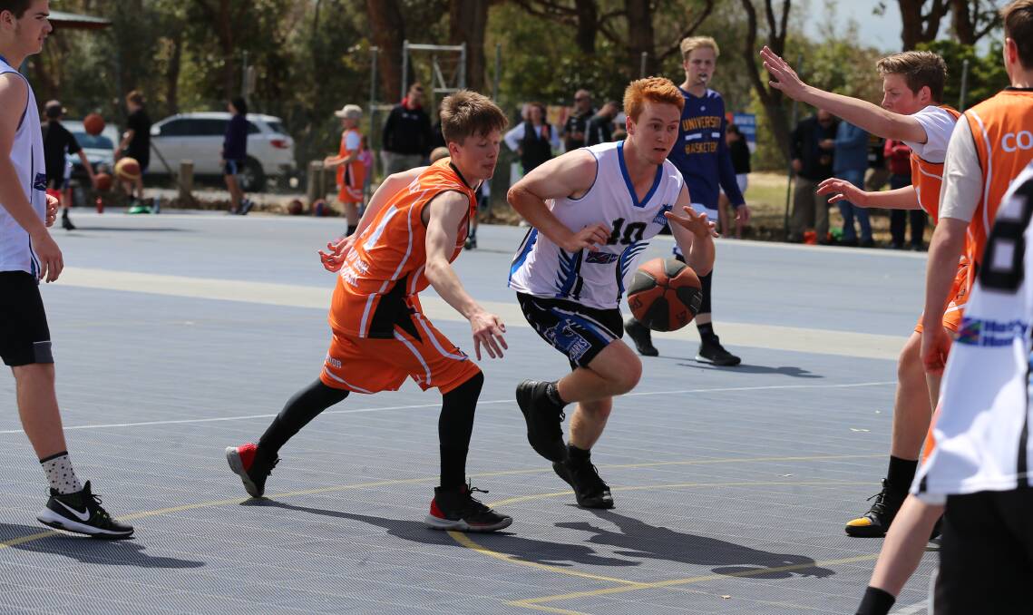 A Merimbula under 18 eludes his Cooma opponent during a good run to the net at the Merimbula Cup competition on Sunday. 