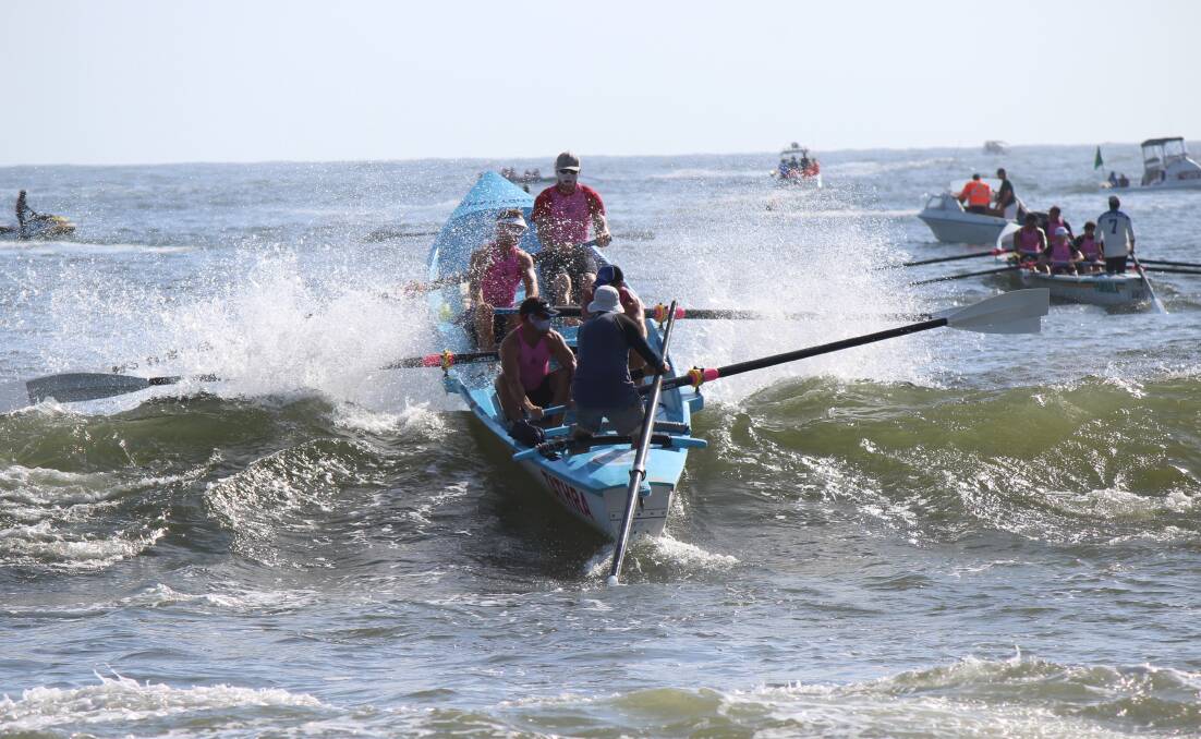 The Tathra men's crew row through the surf to launch the final leg of the 2018 George Bass marathon with 36 crews to contest this year. 
