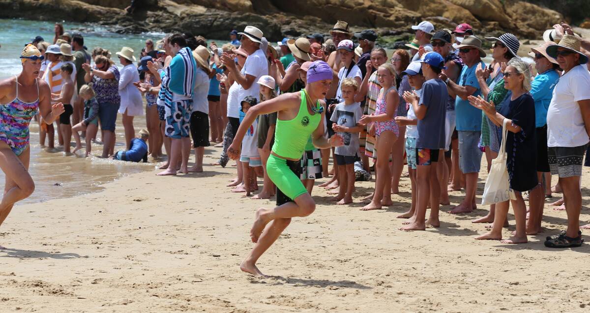 Final sprint: Jack Caldwell makes the last dash up the beach to finish second in the men's division of the Splash for Cash not far behind big sister Georgia on Sunday. 