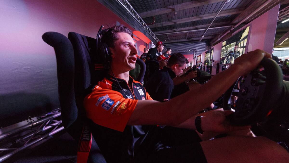 Going online: Nick Percat tries out a simulator during an exhibition at Bathurst in 2017 with the Supercars series to drive a 10-week e-sport series. Picture: Supercars. 