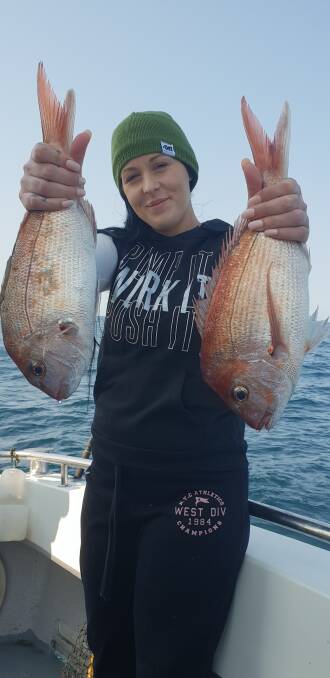 Fish dinner: Ashley Dehnert from Tumut shows a lovely pair of pan sized snapper caught off Haycock Reef from local charter vessel Rathlin 11, captained by Craig Chambers.