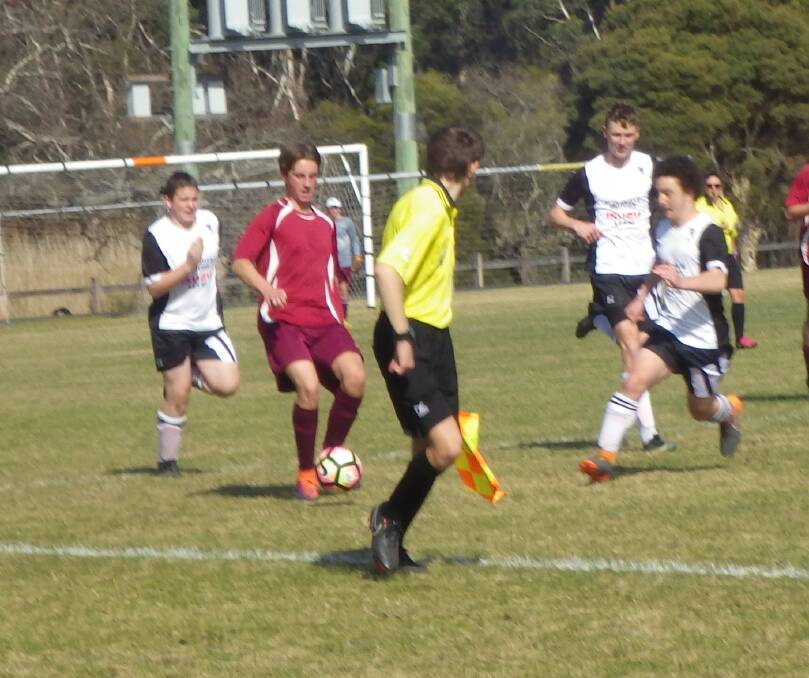 Running it: Nick Fantham takes the ball forward for Tathra during the Under 16’s semi-final game in Pambula. Picture: Hugh Pitty. 