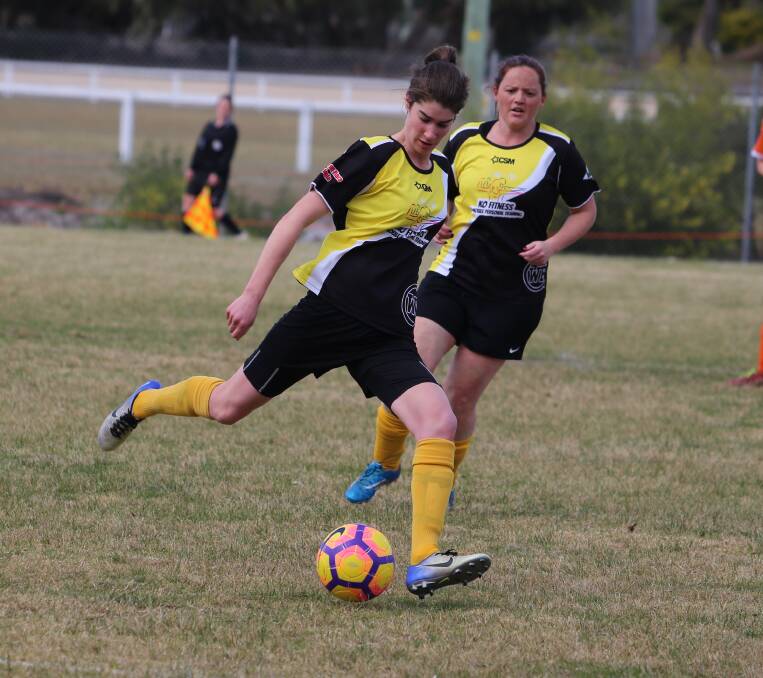 Added reach: Janet King winds up a long range kick with support from Lisa Oldham during Wolumla's win over Pambula last weekend. 