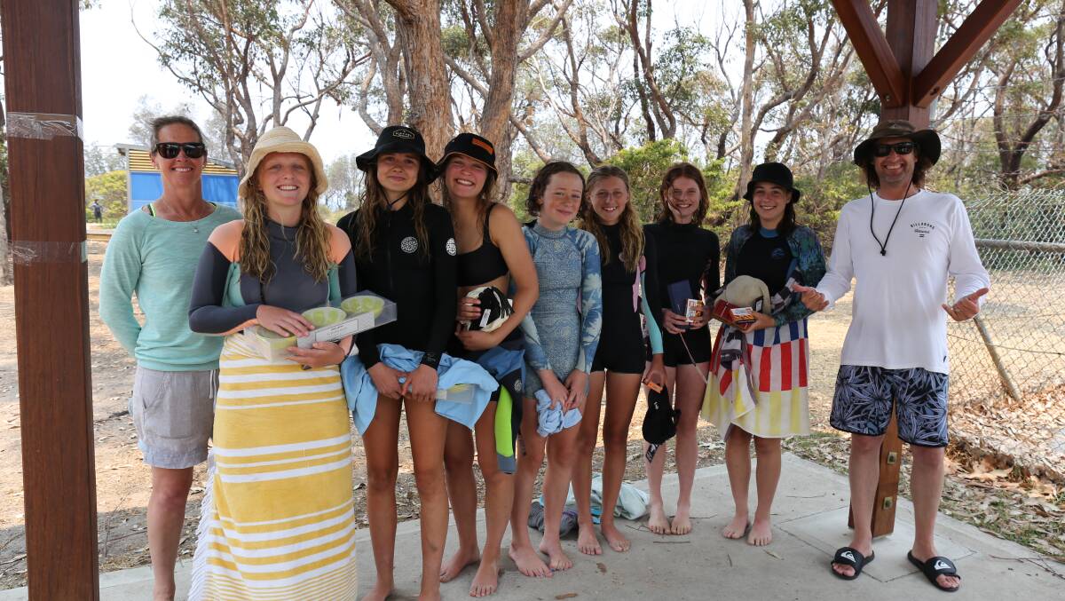 Teachers Jane Hornsby and Jason Morgan congratulate Annie, Emily, Eulalie, Eliza, Lucy, Uluka and Imogen on their efforts in the Jason Bush Memorial surf. 