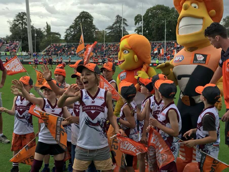 Reprieve: Tathra Sea Eagles juniors cheer on the GWS Giants during a visit to Canberra on the weekend. Picture: AFL NSW/ACT. 