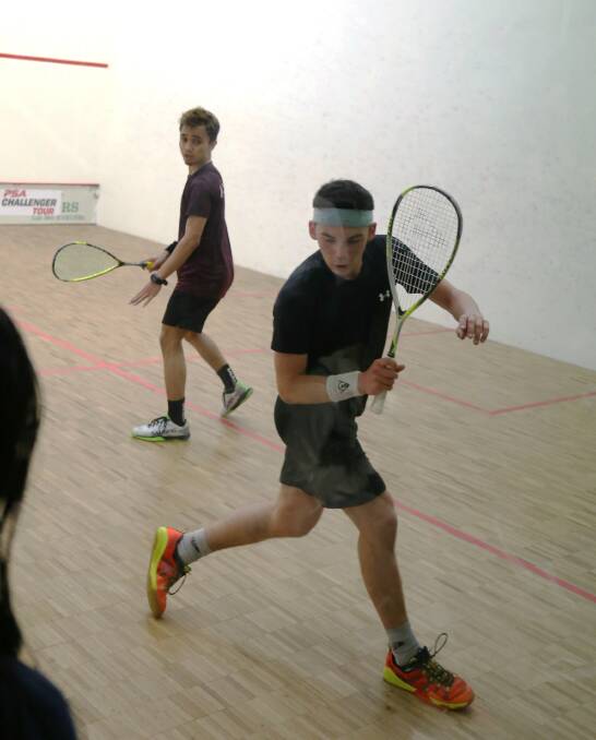 Australian Open winner Victor Crouin (front) looks for a backhand option in his semi-final win over Addeen Adrakie at the Bega squash courts on Saturday. 