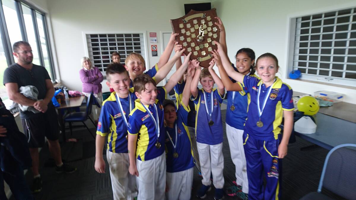 Hold it high: The Bega-Angledale Blues with the under 12s premiership shield after a 'last man standing' win against Tuross Head. Picture: Grant Keogh. 